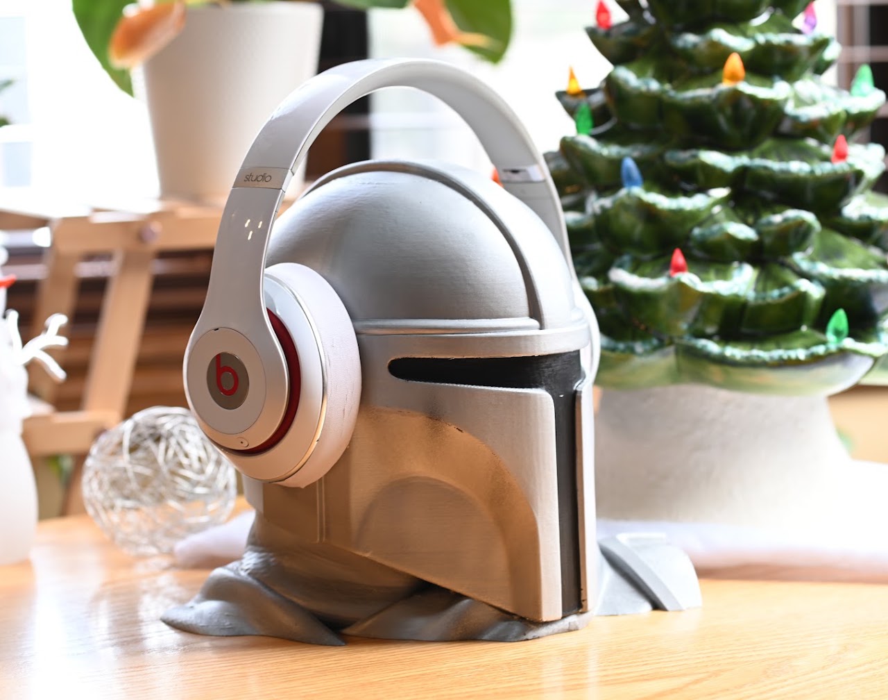 White Beats Studio2 headphones resting on a display helmet