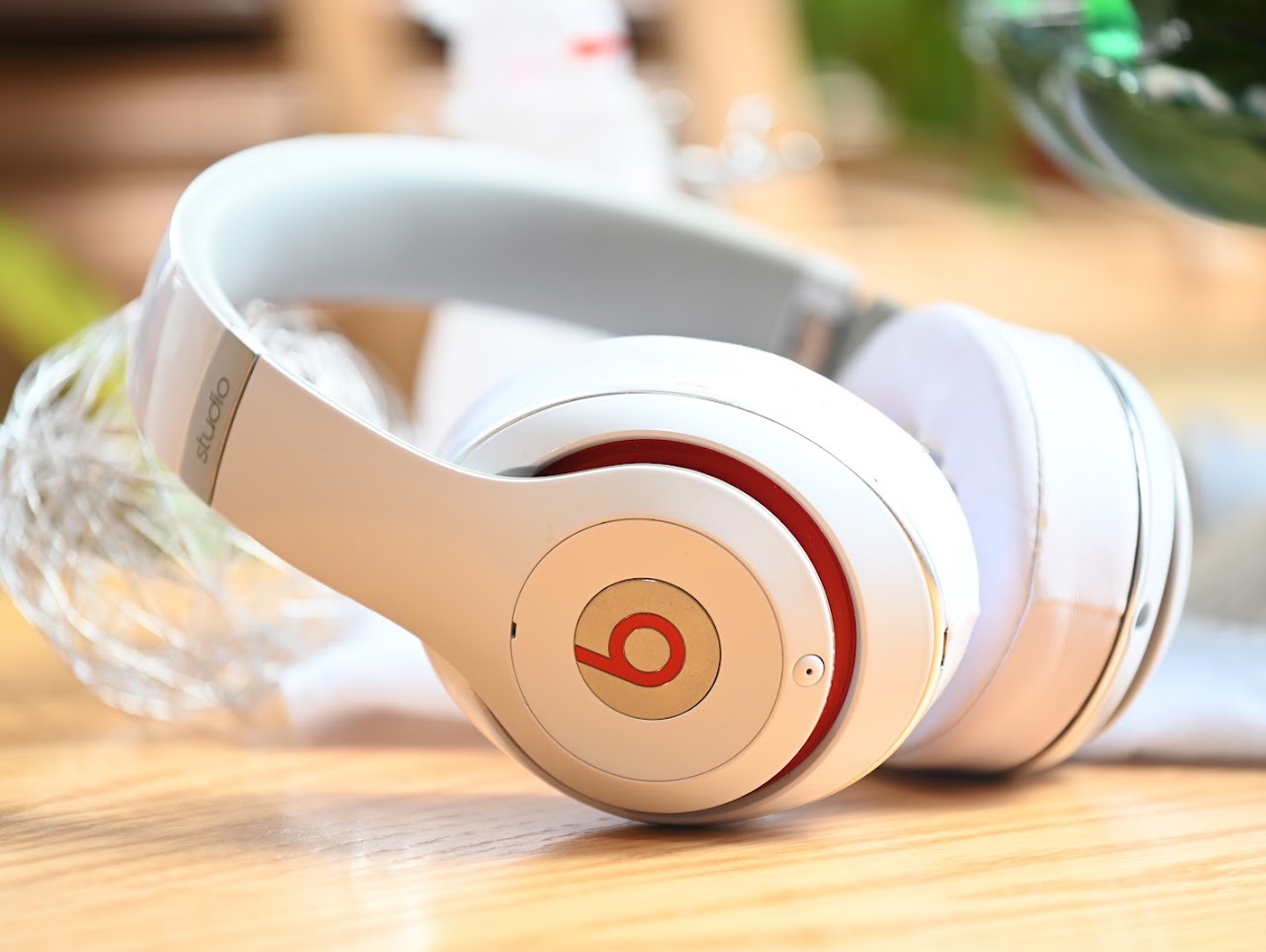 Folded white Beats Studio2 headphones viewed from the ear cup