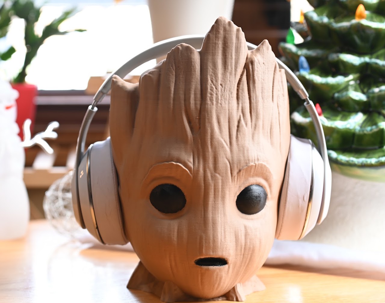 White Beats Studio2 headphones on a carved wooden head display