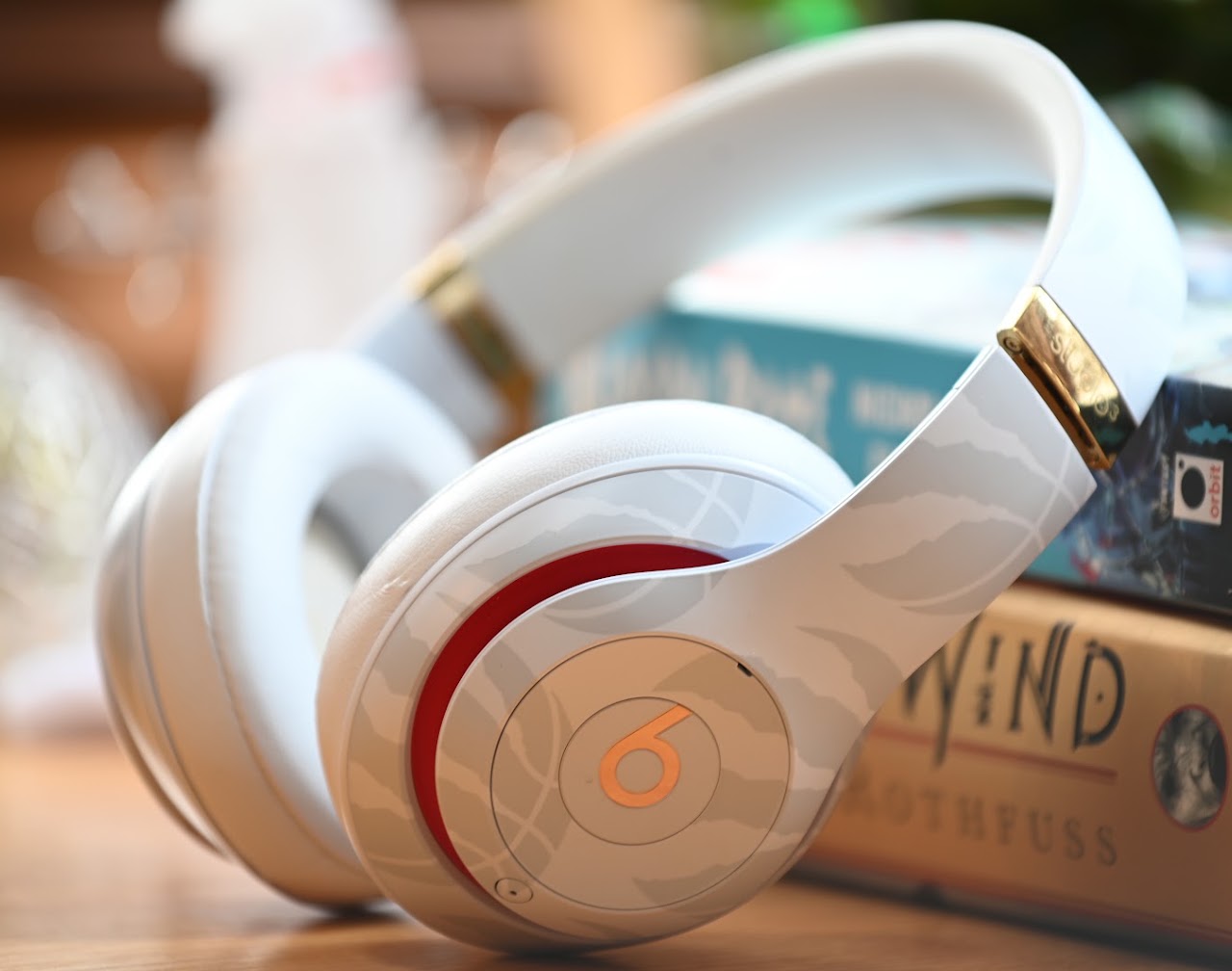 White Beats Studio3 headphones standing beside books
