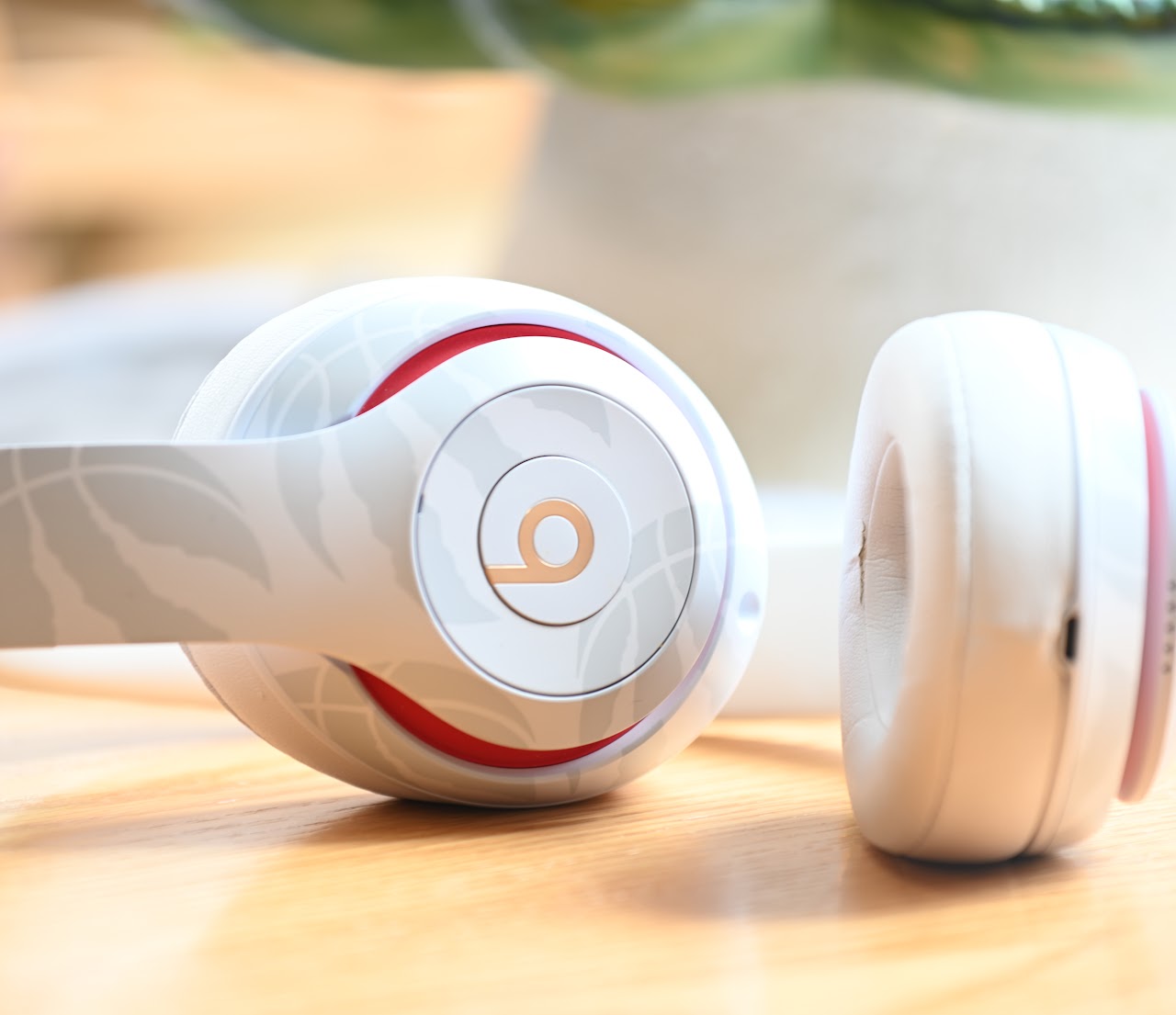 White Beats Studio3 headphones opened on a wooden table