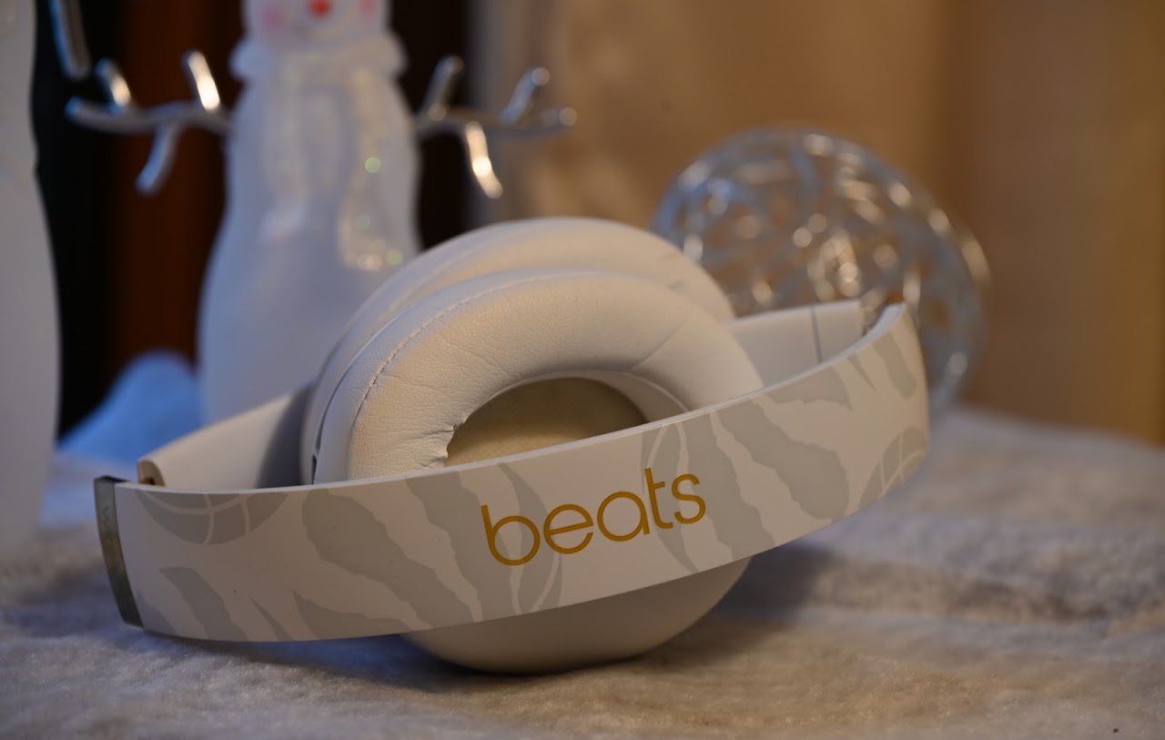 Folded white Beats Studio3 headphones on a soft surface