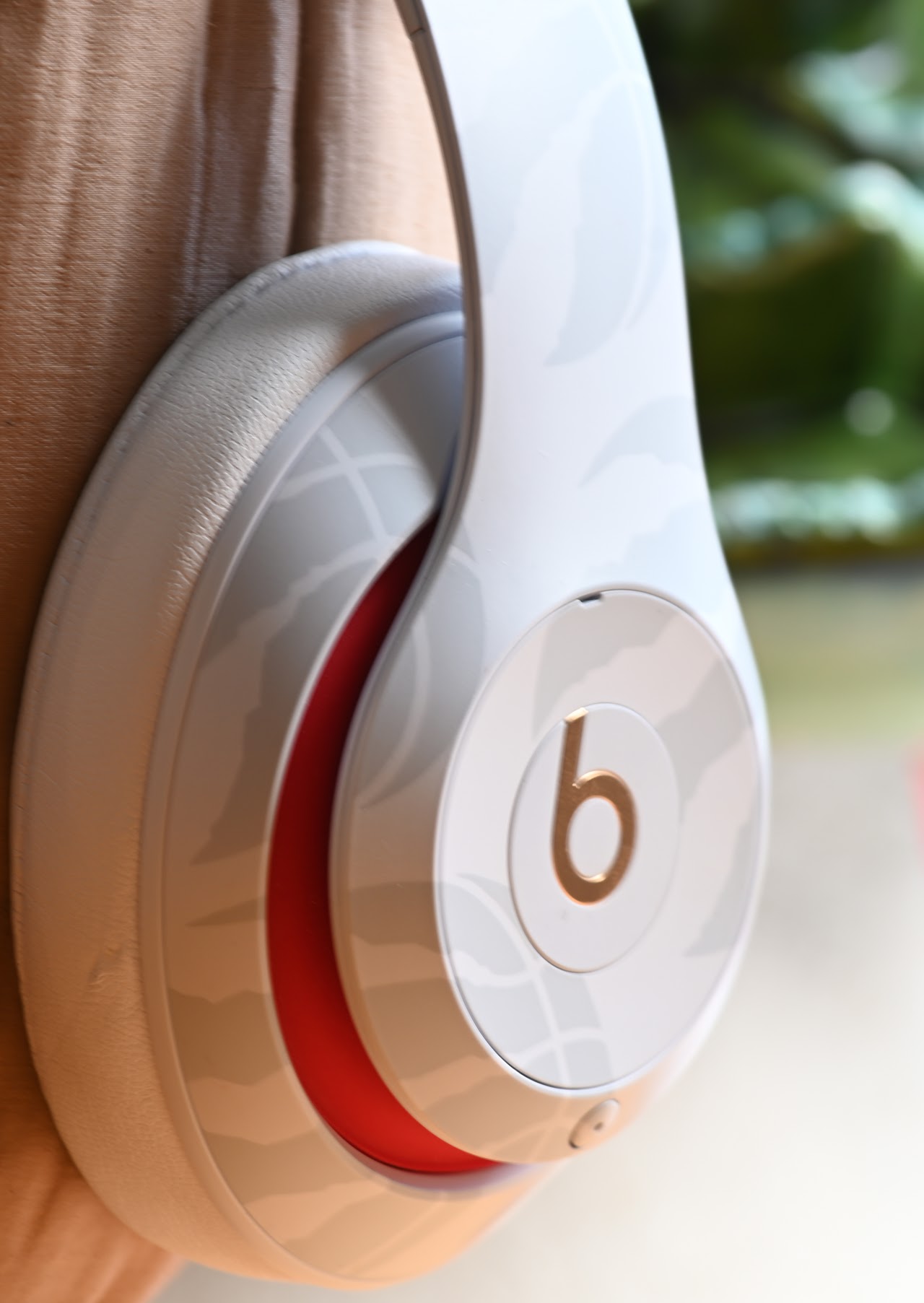 Close view of a white Beats Studio3 ear cup on a display helmet