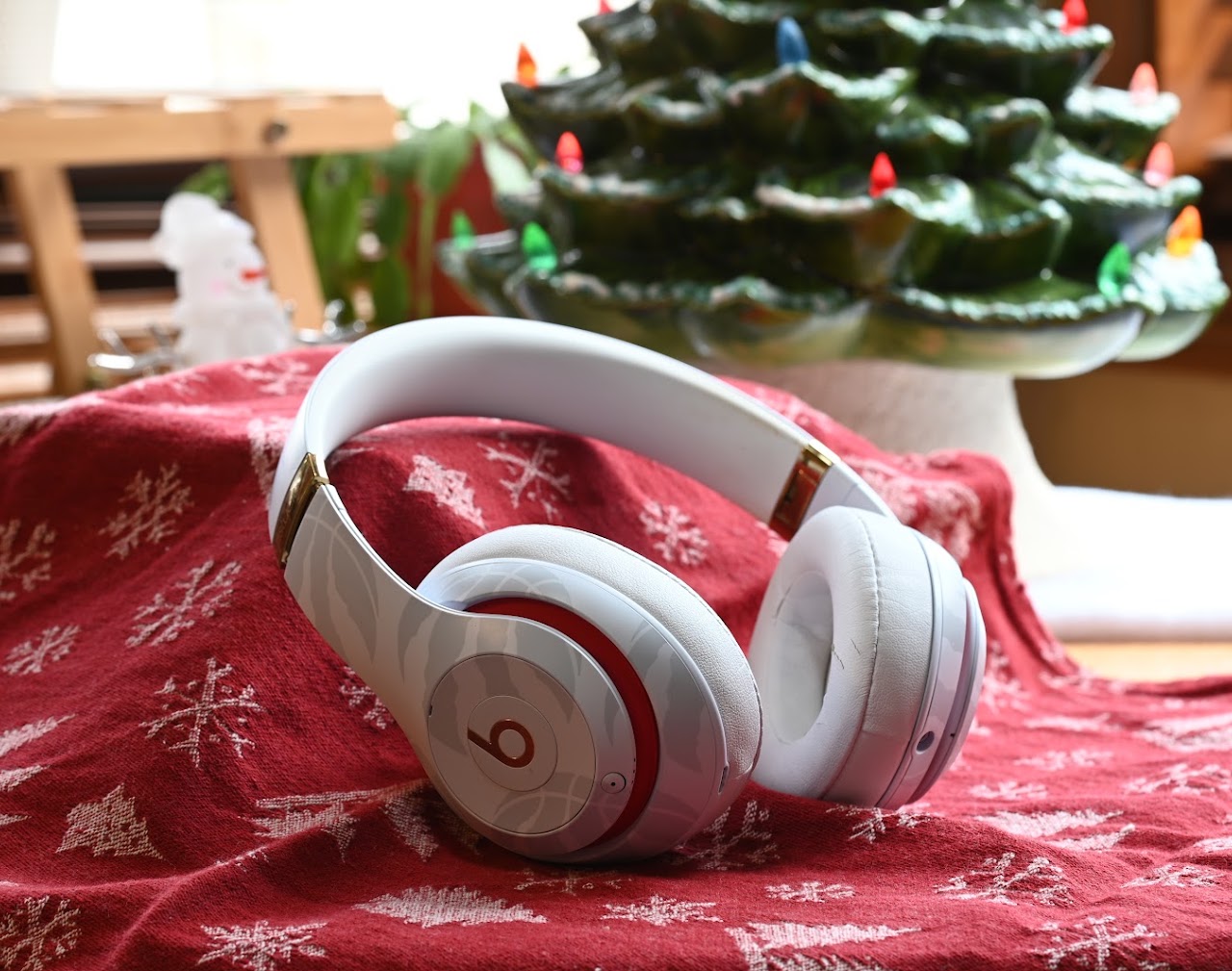 White Beats Studio3 headphones on a red patterned cloth