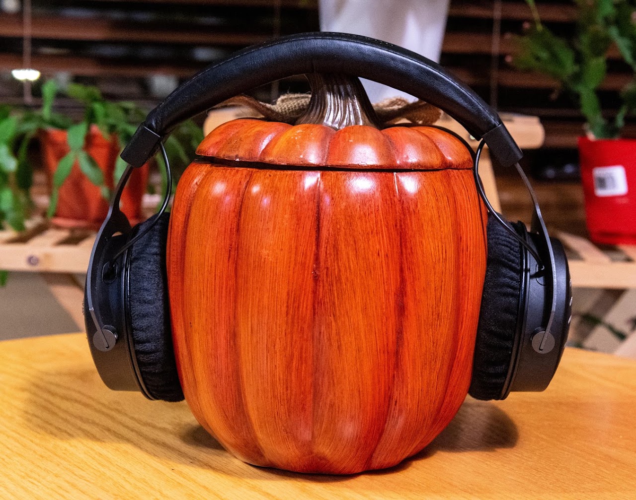 Beyerdynamic DT 1990 Pro headphones on a carved wooden head display