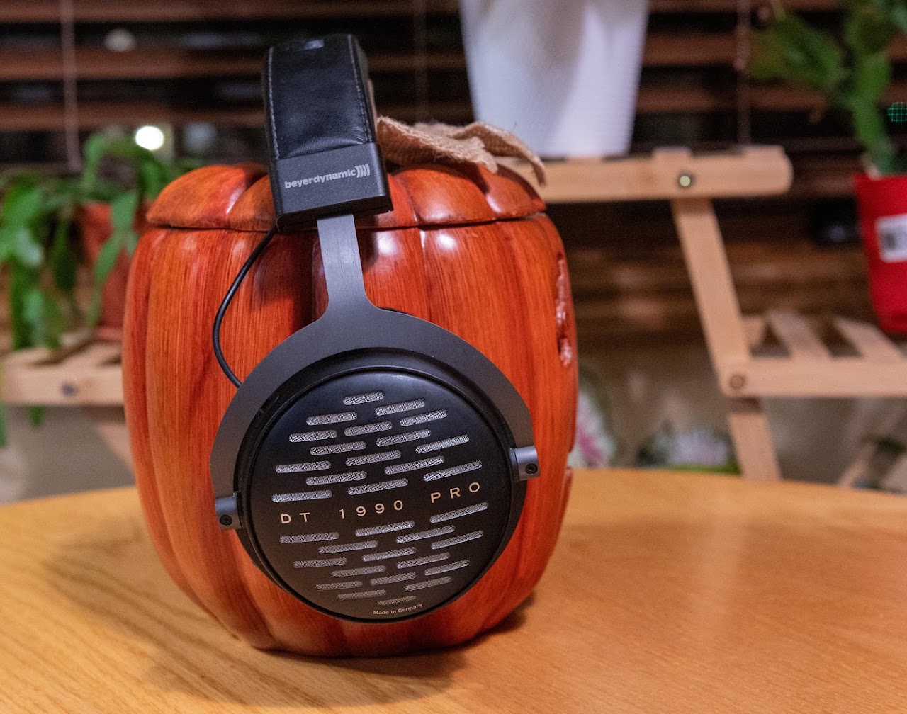 Side view of Beyerdynamic DT 1990 Pro headphones on a wooden display