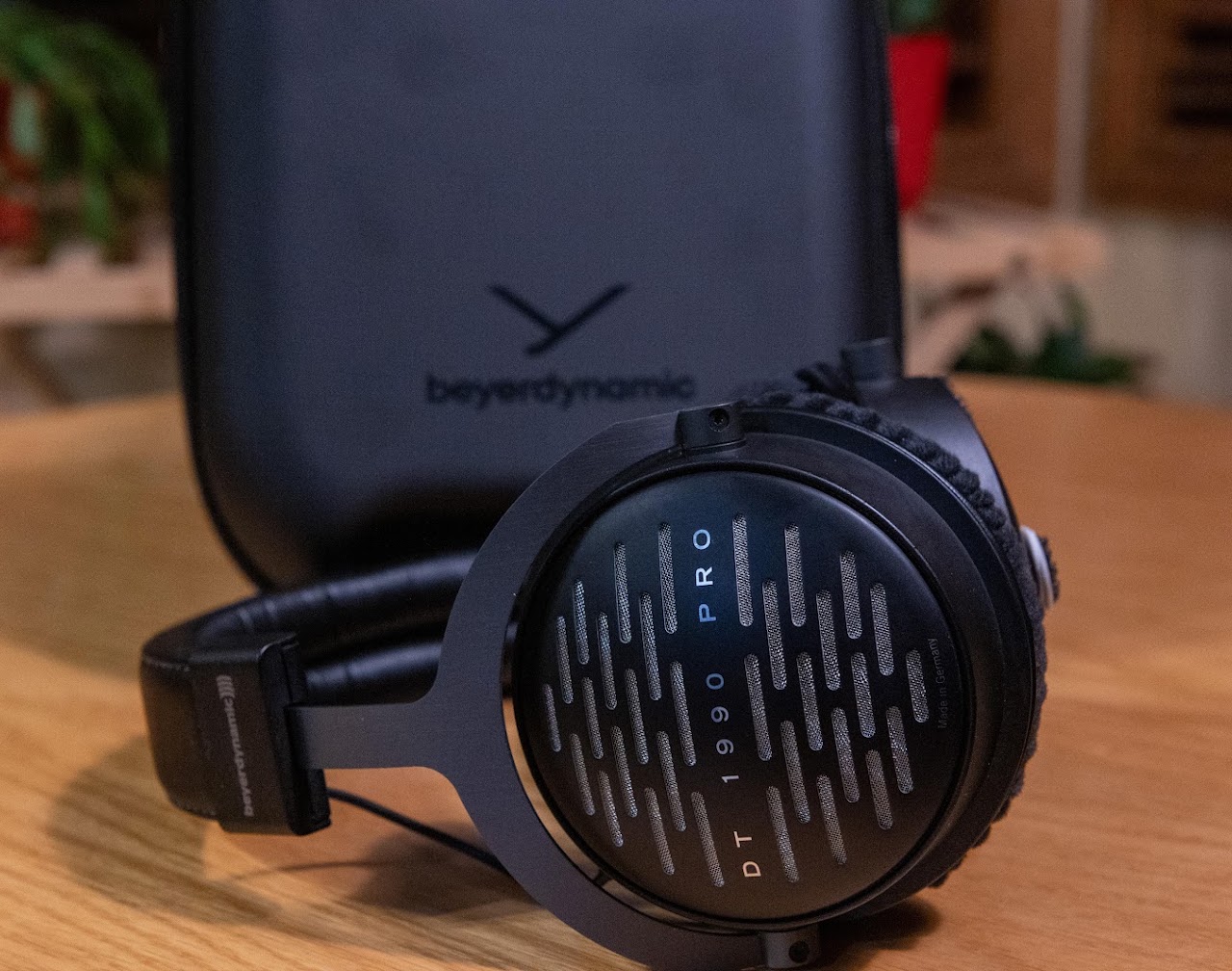Beyerdynamic DT 1990 Pro headphones beside their carrying case