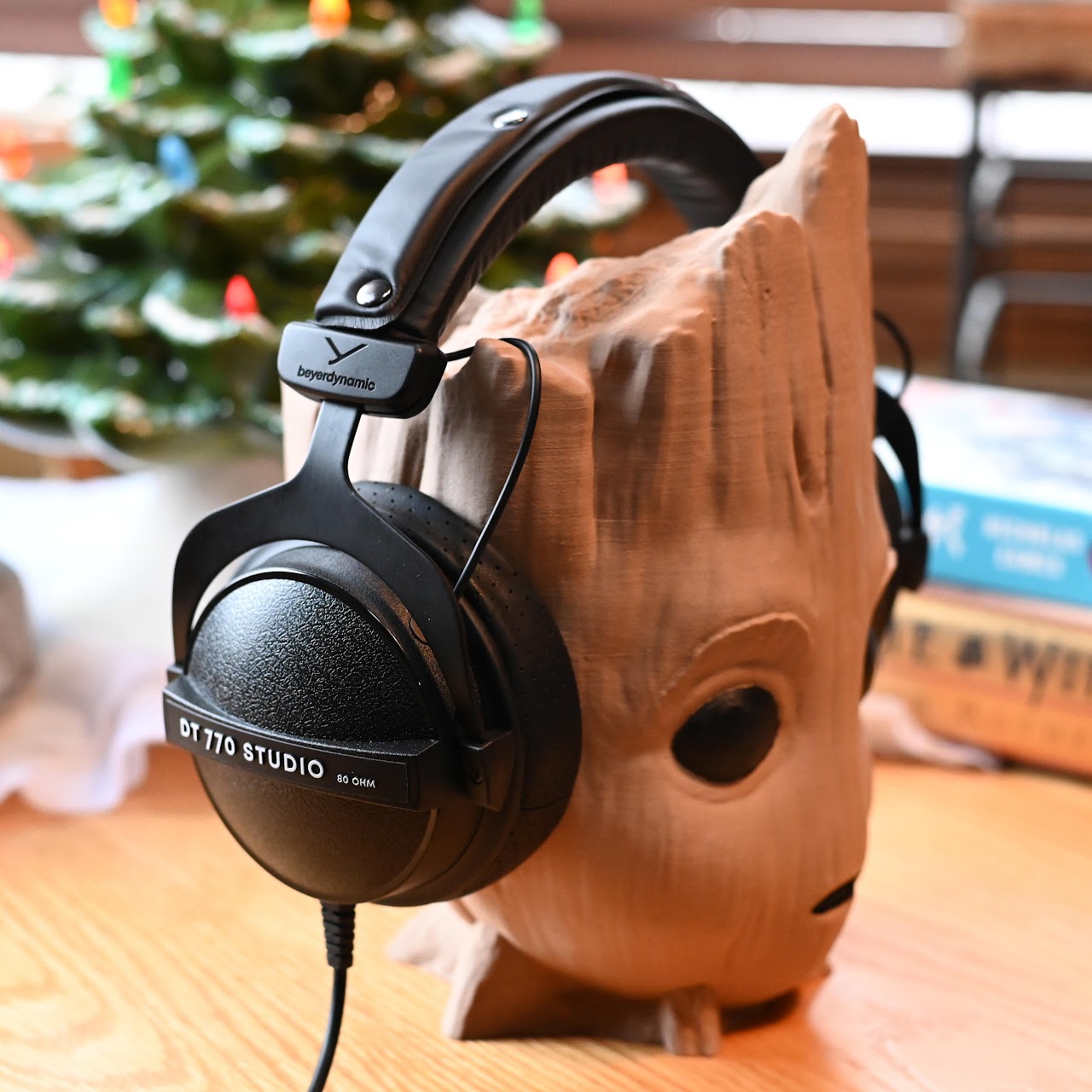 Beyerdynamic DT 770 headphones on a carved wooden head display