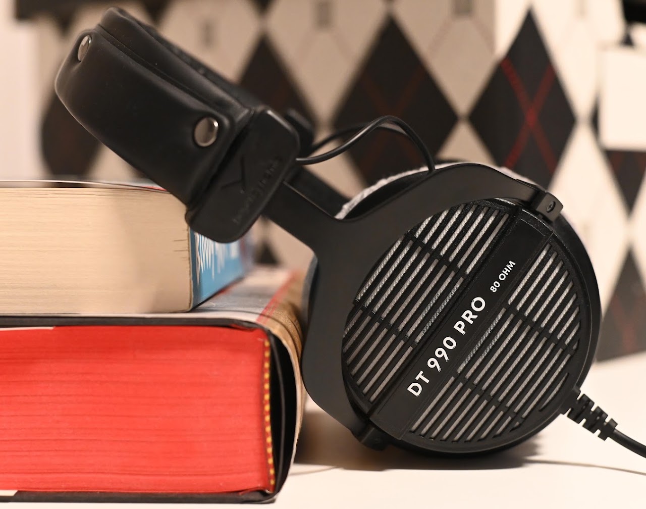 Side view of Beyerdynamic DT 990 Pro headphones beside a book