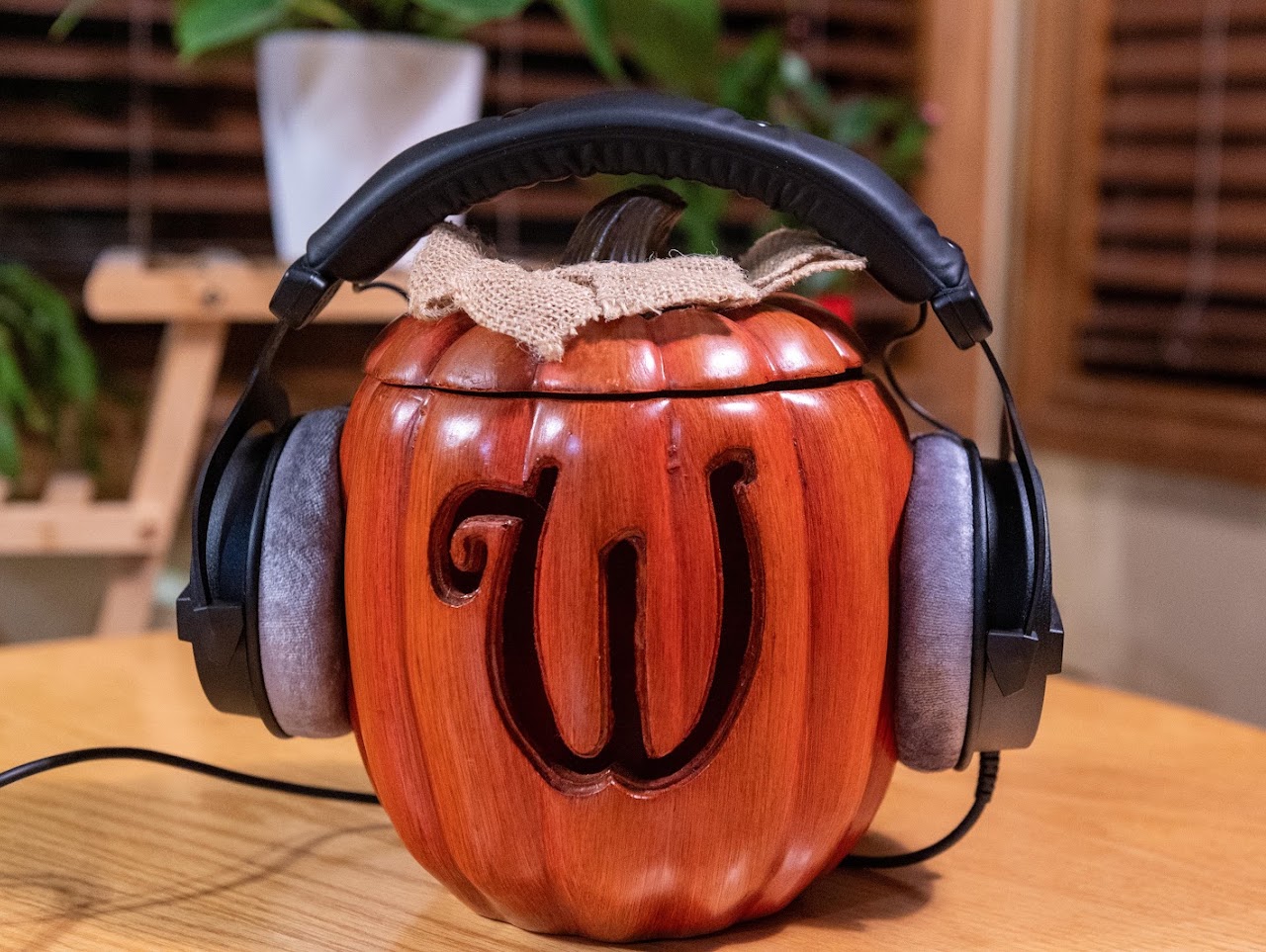 Beyerdynamic DT 990 Pro headphones on a carved wooden head display
