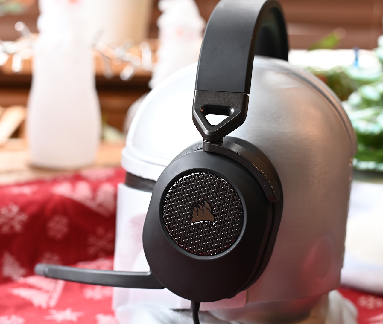 Corsair HS65 headset beside books on a red patterned cloth