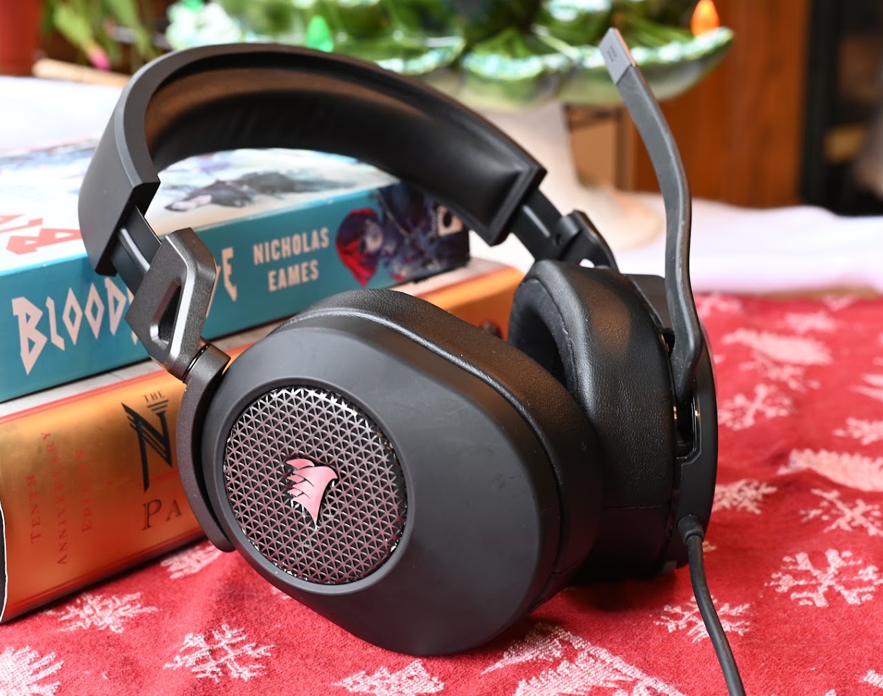 Corsair HS65 headset resting on books