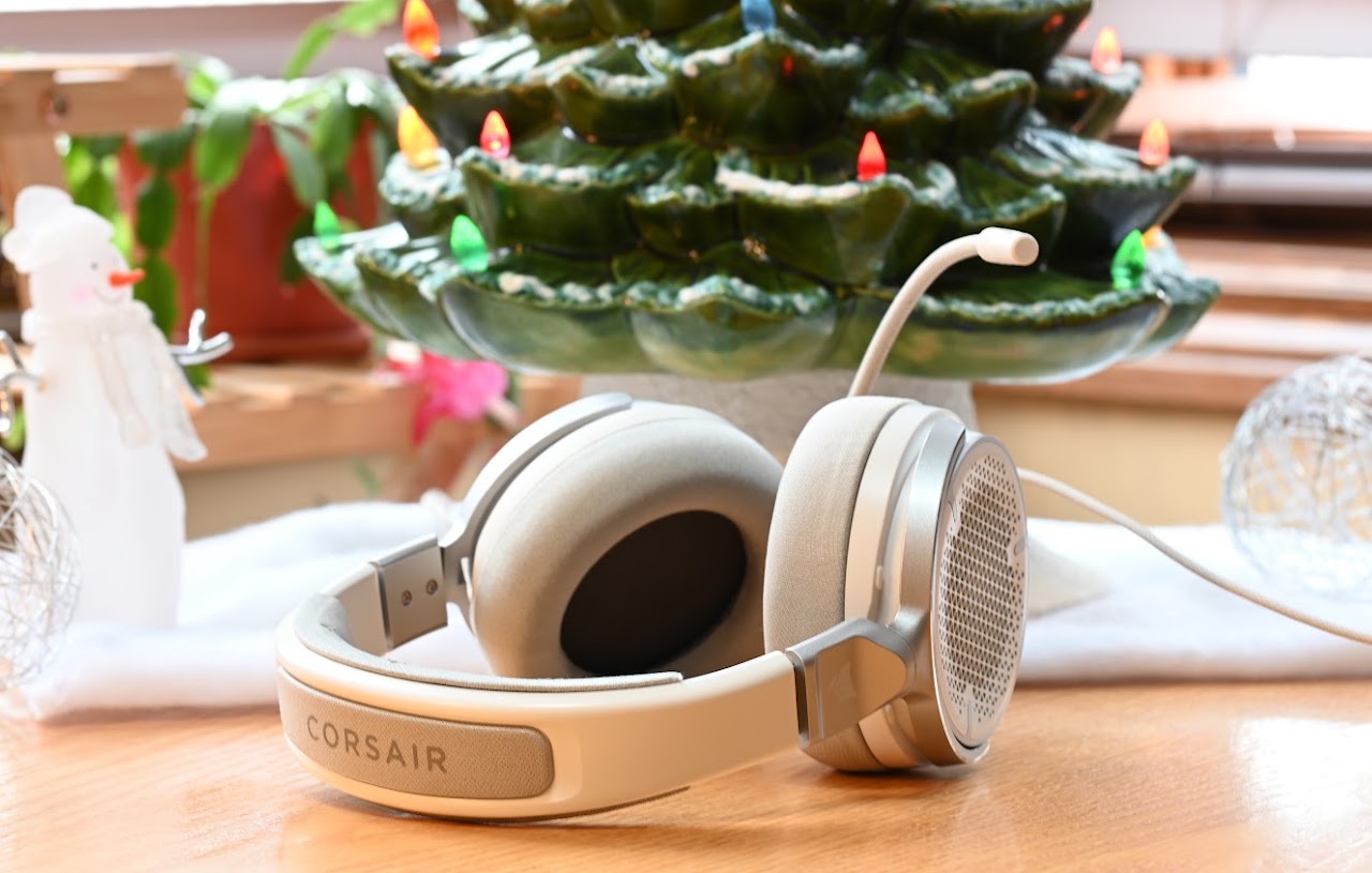 Folded white Corsair Virtuoso Pro headset on a wooden table