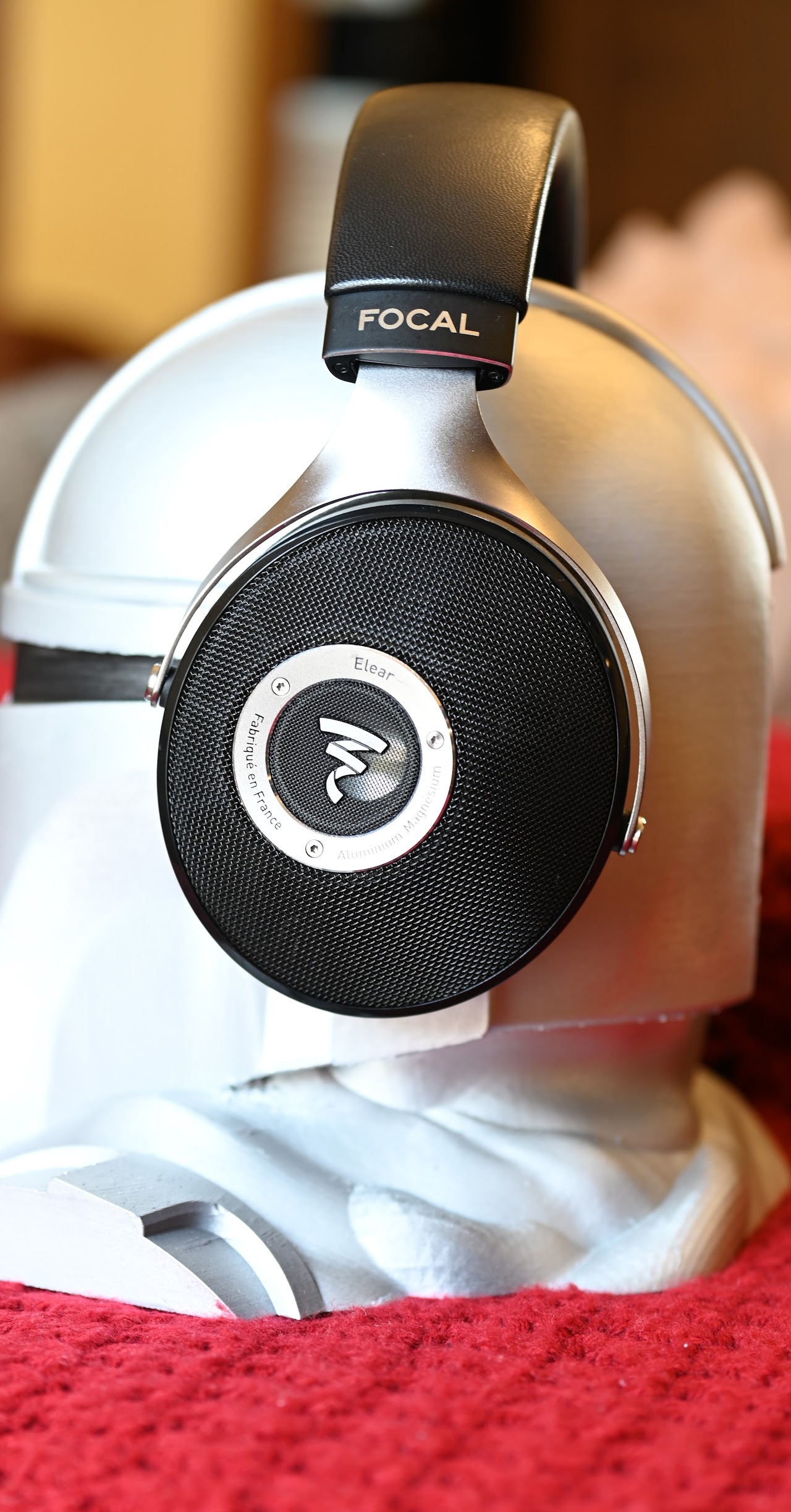 Focal Elear headphones on a carved wooden head display