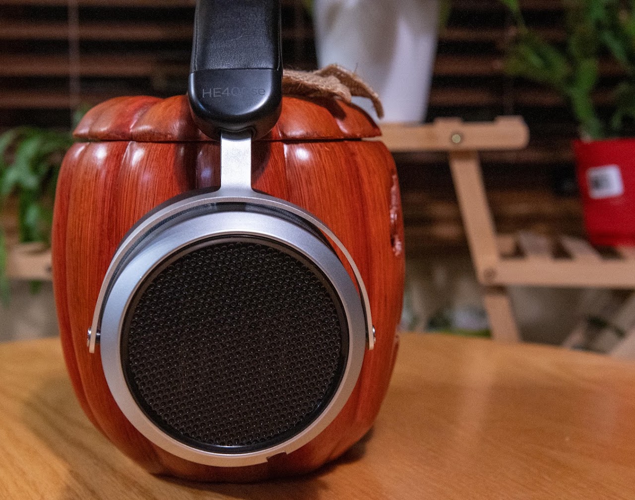Hifiman HE400se headphones on a carved wooden display